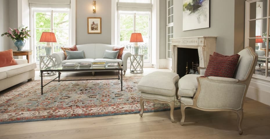 Dining room with a wooden table, cane chairs and a damask red wall