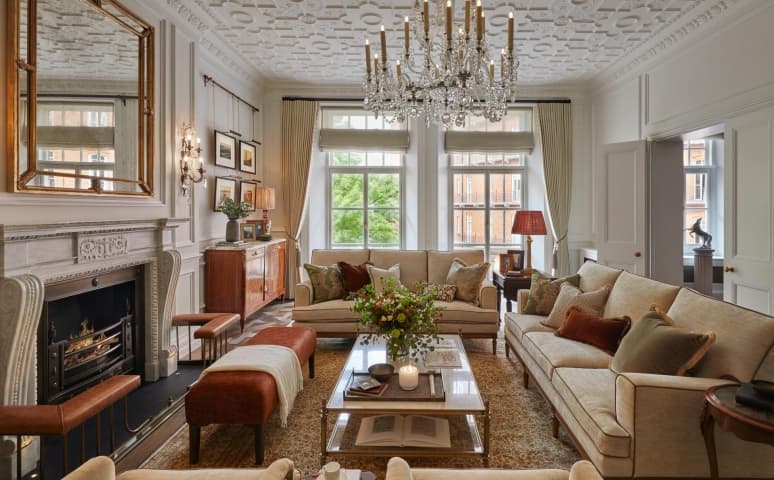 Dining room with a wooden table, cane chairs and a damask red wall